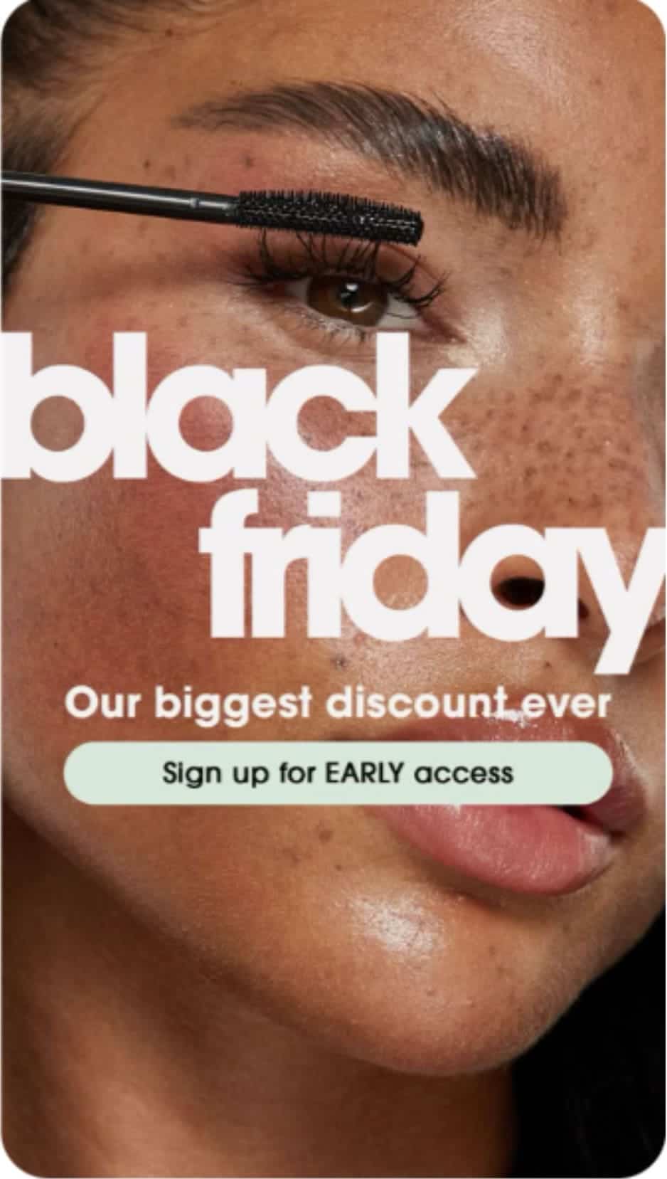 Close-up of woman applying mascara with bold text reading Black Friday. Pinterest Black Friday marketing strategy example promoting early access signups and beauty discounts.