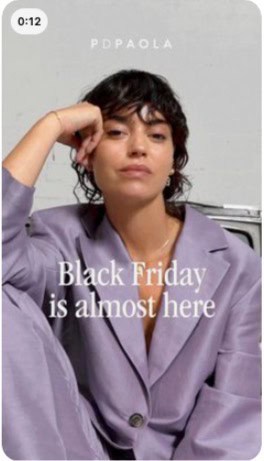 Woman in lilac suit with text Black Friday is almost here. Pinterest Black Friday marketing strategy example for jewellery and fashion brands creating anticipation.
