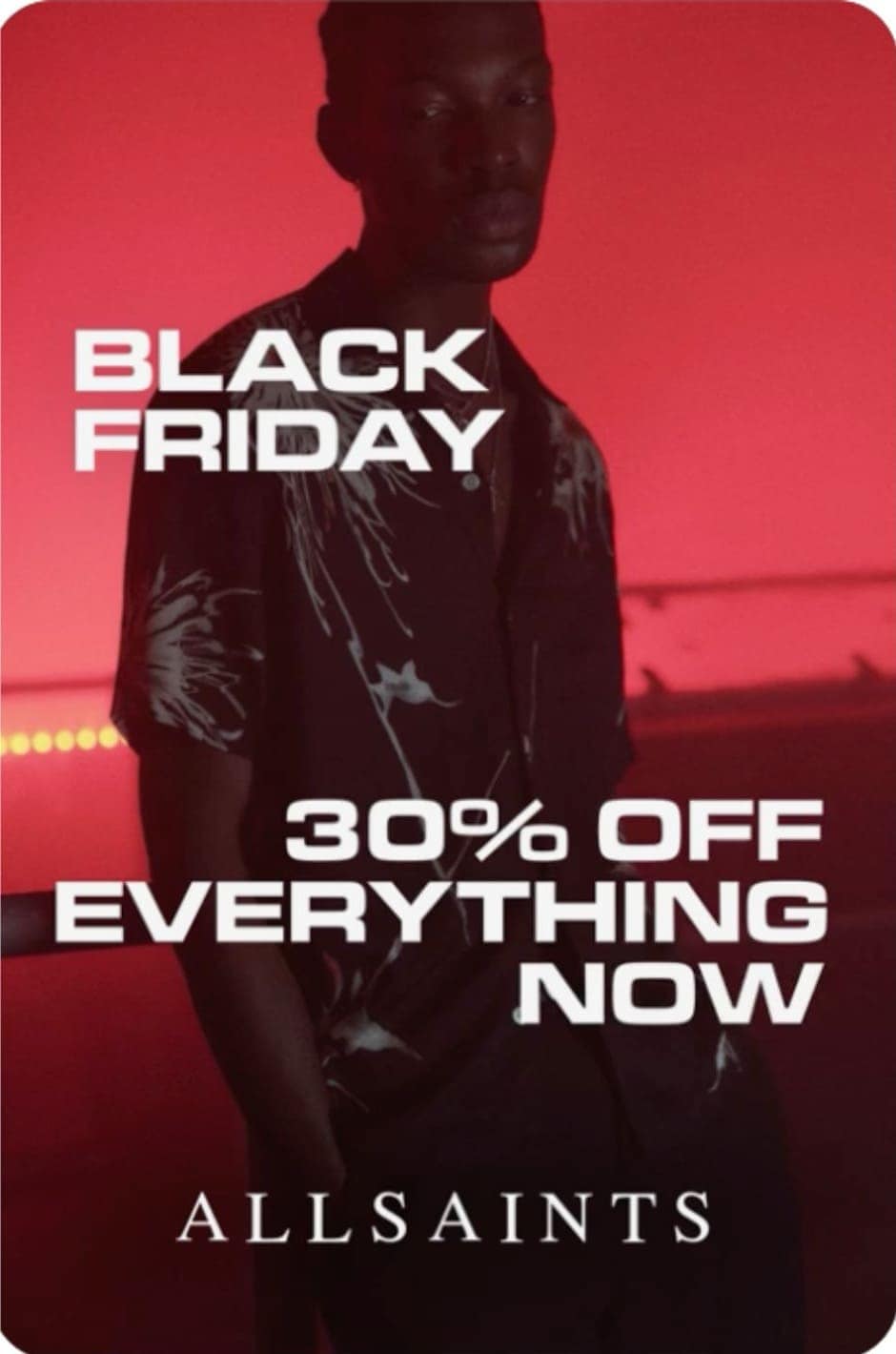 Male model in dark shirt with red background, text Black Friday 30% off everything. Pinterest Black Friday marketing strategy featuring edgy fashion campaign.