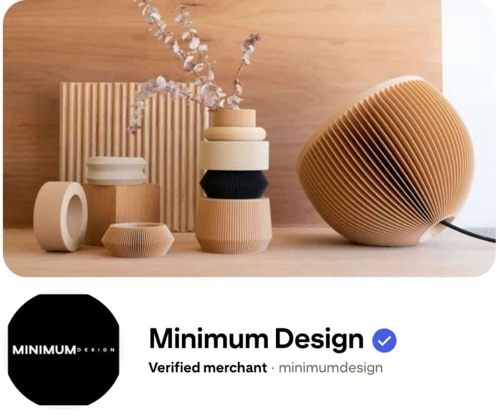 Minimal wooden home décor and sculptural lighting displayed on a shelf above a verified merchant profile, illustrating a Pinterest marketing for Shopify brand focused on clean, modern product presentation.